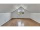 An attic space with a window and wood-look flooring, bathed in natural light at 2402 Harper St, Tampa, FL 33605