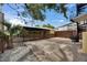 An outdoor living space featuring a brick patio, a parking area, and lush tree coverage at 2402 Harper St, Tampa, FL 33605