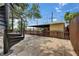 Backyard with a fenced-in yard, brick pavers, a shed, and a spiral staircase in a charming setting at 2402 Harper St, Tampa, FL 33605