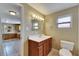 Bathroom featuring a vanity with a mirror, sink and toilet, and a view to the kitchen at 2402 Harper St, Tampa, FL 33605