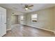 Bright bedroom features a ceiling fan, wood-look flooring, and a mirrored closet for ample storage at 2402 Harper St, Tampa, FL 33605