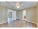 Bedroom featuring wood floors, ceiling fan, and view to connected room and bathroom at 2402 Harper St, Tampa, FL 33605