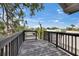 Relaxing outdoor deck with a railing and mature trees offering a serene view at 2402 Harper St, Tampa, FL 33605