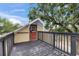 Outdoor deck with a railing, orange door, and mature tree offering a relaxing view at 2402 Harper St, Tampa, FL 33605