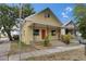 Charming yellow two-story home with covered front porch and landscaped front yard at 2402 Harper St, Tampa, FL 33605