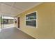 Side view of a sunny yellow home featuring a quaint front porch and large windows at 2402 Harper St, Tampa, FL 33605