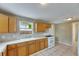 Open kitchen with light wood cabinets, white countertops, and a gas stove at 2402 Harper St, Tampa, FL 33605