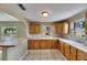 Well-lit kitchen featuring ample counter space, functional cabinets, and a convenient breakfast bar area at 2402 Harper St, Tampa, FL 33605