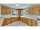 Bright kitchen featuring tile floors, light wood cabinetry, and a white countertop and sink at 2402 Harper St, Tampa, FL 33605