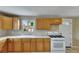 Bright kitchen featuring wood cabinetry, white countertops, and a white stove at 2402 Harper St, Tampa, FL 33605