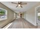 Spacious living room featuring updated flooring, abundant natural light, and a seamless connection to the kitchen at 2402 Harper St, Tampa, FL 33605