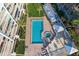Aerial view of condo building showing pool, hot tub, and outdoor lounge and grilling area at 2504 Gulf Blvd # 201, Indian Rocks Beach, FL 33785