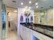 Bright bathroom boasts a granite countertop, tiled wall, and mirrored sliding door to the shower at 2504 Gulf Blvd # 201, Indian Rocks Beach, FL 33785
