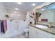 Bathroom with walk-in tub, tile flooring, and granite countertops with a large mirror at 2504 Gulf Blvd # 201, Indian Rocks Beach, FL 33785