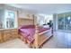 Bright bedroom features a king bed and balcony access at 2504 Gulf Blvd # 201, Indian Rocks Beach, FL 33785