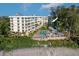 Lovely condo building with a refreshing swimming pool and lush tropical landscaping, near beach at 2504 Gulf Blvd # 201, Indian Rocks Beach, FL 33785