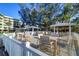 A large deck with tables, chairs, and umbrellas for community residents at 2504 Gulf Blvd # 201, Indian Rocks Beach, FL 33785