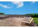 Lounge chairs are set on a deck with ocean views and direct beach access at 2504 Gulf Blvd # 201, Indian Rocks Beach, FL 33785