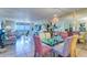 Bright dining room featuring a glass table, colorful chairs, chandelier and views of the ocean at 2504 Gulf Blvd # 201, Indian Rocks Beach, FL 33785