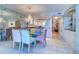 Dining room with mirrored wall, chandelier, decorative bar, and an open view of the kitchen at 2504 Gulf Blvd # 201, Indian Rocks Beach, FL 33785