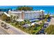 Beautiful condo building with lush landscaping, covered parking, and close beach access at 2504 Gulf Blvd # 201, Indian Rocks Beach, FL 33785