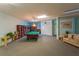 Large game room with a pool table, piano, library, and seating area at 2504 Gulf Blvd # 201, Indian Rocks Beach, FL 33785