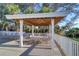 A large gazebo with a ceiling fan, multiple tables, and chairs on the deck at 2504 Gulf Blvd # 201, Indian Rocks Beach, FL 33785