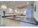 A spacious kitchen featuring white cabinets, granite countertops, and modern appliances at 2504 Gulf Blvd # 201, Indian Rocks Beach, FL 33785