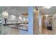 Spacious kitchen with granite counters, and an arched entry to the hallway at 2504 Gulf Blvd # 201, Indian Rocks Beach, FL 33785