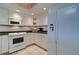 Bright kitchen with white appliances, backsplash and under cabinet lighting at 2504 Gulf Blvd # 201, Indian Rocks Beach, FL 33785