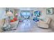 Cozy living room with tile floors, ocean views, comfortable seating, and a modern entertainment center at 2504 Gulf Blvd # 201, Indian Rocks Beach, FL 33785