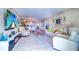 Open-concept living room with tile floors, comfortable seating, and a view into the modern kitchen at 2504 Gulf Blvd # 201, Indian Rocks Beach, FL 33785