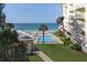 Aerial view showcasing the ocean, pool, and building, offering serene outdoor living and a coastal lifestyle at 2504 Gulf Blvd # 201, Indian Rocks Beach, FL 33785
