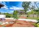 Landscaped backyard featuring mulch, a tree and a wooden fence at 2524 Laurelwood Ln, Valrico, FL 33596