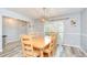 Bright dining area featuring wood floors, ample natural light, and modern lighting at 2524 Laurelwood Ln, Valrico, FL 33596