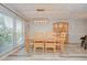 Bright dining area featuring wood floors, ample natural light, and modern lighting at 2524 Laurelwood Ln, Valrico, FL 33596