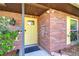 Inviting entryway with red brick, decorative door accents, and manicured landscaping at 2524 Laurelwood Ln, Valrico, FL 33596
