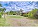 Charming home with a well-manicured front yard and mature landscaping under a partly cloudy sky at 2524 Laurelwood Ln, Valrico, FL 33596