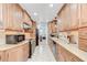 Well-lit kitchen featuring warm wood cabinets, granite countertops and stainless steel appliances at 2524 Laurelwood Ln, Valrico, FL 33596