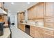 Modern kitchen showcasing warm wood cabinets, granite countertops, and stainless steel appliances at 2524 Laurelwood Ln, Valrico, FL 33596