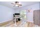 Office featuring an adjustable desk, ceiling fan and a window offering natural light at 2524 Laurelwood Ln, Valrico, FL 33596