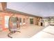 Enclosed patio featuring a swing, outdoor kitchen, and brick accent wall at 2524 Laurelwood Ln, Valrico, FL 33596
