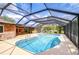 Screened in pool with a brick house and blue skies at 2524 Laurelwood Ln, Valrico, FL 33596