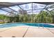 Screened-in pool with lounge area and lush landscaping offers a private outdoor oasis at 2524 Laurelwood Ln, Valrico, FL 33596