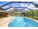 Screened in pool and patio featuring a brick house and an outdoor bar at 2524 Laurelwood Ln, Valrico, FL 33596