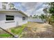 Home's backyard featuring a chainlink fence, privacy fence, and abundant greenery at 2608 Browning St, Sarasota, FL 34237