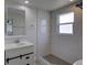 Bathroom features white tile, a granite vanity, and bright lighting at 2608 Browning St, Sarasota, FL 34237