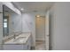 Bright bathroom with granite countertop, white cabinetry, and tile flooring at 2608 Browning St, Sarasota, FL 34237