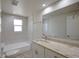 Bathroom features white tile, a granite vanity, and bright lighting at 2608 Browning St, Sarasota, FL 34237
