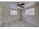 Bedroom with two windows and wood-look flooring and ceiling fan at 2608 Browning St, Sarasota, FL 34237